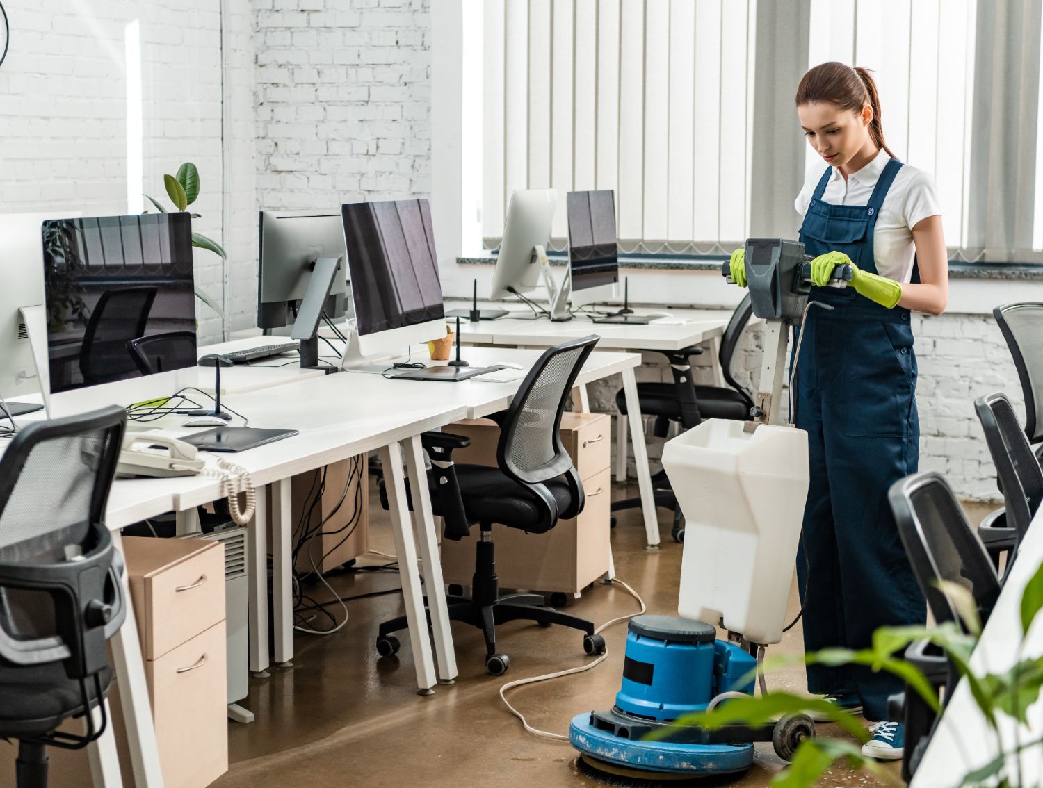 young-cleaner-washing-floor-in-open-space-office